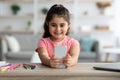 Gadgets And Kids. Cute Little Arab Girl Using Smartphone At Home Royalty Free Stock Photo