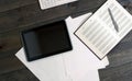 Gadgets on the wooden table. Computer tablet documents.