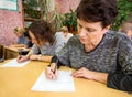 Adults at school desks are being tested in Russian language