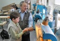 The boy works on a lathe in a school workshop