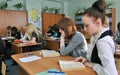 Students in the class carefully read the textbooks in the classroom