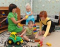 Kindergarten teachers play with children