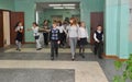 The teacher walks with the children along the school corridor