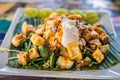 Gado-gado Indonesian salad served with peanut sauce. Ingredients: tofu, spinach, string beans, soy sprouts, potatoes, cucumber and