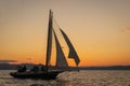 gaff-rigged sloop at sunset Royalty Free Stock Photo