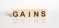 GAINS word from wooden blocks on the white desk Royalty Free Stock Photo