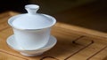 Gaiwan on chaban selective focus. Tea ceremony gong fu cha. Chinese white pottery Dehua white Chinese porcelain gaiwan Royalty Free Stock Photo