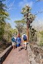 Galapagos, Ecuador, 22 july, 2019. A father with his son and a guide walk along the path to the Tortuga Bay beach in the Galapagos