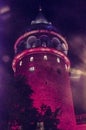 Galata tower in istanbul in red color in night with a purple back ground