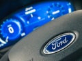 Galati, Romania - September 05, 2020: Focus on Ford logo on steering wheel, out of focus of the dashboard, speedometer and