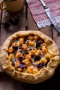 Galette with cheese on wooden table.