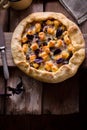 Galette with cheese on wooden table.