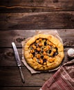 Galette with cheese on wooden table.