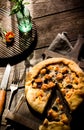 Galette with cheese on wooden table.