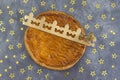 Galette des rois, french kingcake with a golden crown on a grey slate background scattered with golden stars Royalty Free Stock Photo