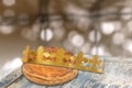 Galette des rois, french kingcake with a golden crown, on wooden table ,epiphany cake against blury light Royalty Free Stock Photo