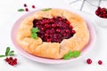 Galette with lingonberry on the white table