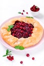 Galette with lingonberry on the white table