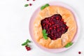 Galette with lingonberry on the white table