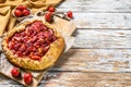 Galette with strawberry and rhubarb. Homemade tart, tarte. White wooden background. Top view. Copy space Royalty Free Stock Photo