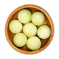 Galia melon balls, also known as sarda melon, in a wooden bowl