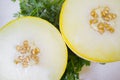 Galia melon break in half over parsley background Royalty Free Stock Photo