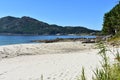 Beach with mountain, forest and rocks. Grass, vegetation and pine trees. Sunny day, blue sky. Galicia, Spain. Royalty Free Stock Photo