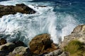 Waves splashing against the rocks. Blue sea with white foam, Galicia, Spain. Royalty Free Stock Photo