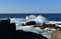 Big waves splashing against the rocks. Blue sea with white foam, sunny day. Galicia, Spain. Royalty Free Stock Photo