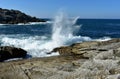 Waves splashing against the rocks. Blue sea with white foam, sunny day, clear sky. Galicia, Spain. Royalty Free Stock Photo