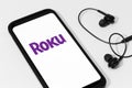 ROKU logo on Smart phone screen on white table