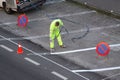 Road painter painting lines on asphalt using a paint sprayer gun