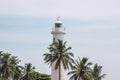 Galle lighthouse with palm trees in sky