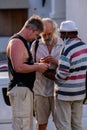 Galle, Sri Lanka - 02 03 2022: Antique dealers and foreign buyers meet up. Senior tourists inspecting old coins, the concept of