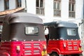 Galle, Sri Lanka - April 2018: Rear view of red and black Tuktuk taxis, in a typical streetscape Royalty Free Stock Photo