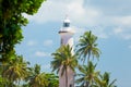 GALLE, SRI LANKA - JANUARY 26, 2016: beautiful lighthouse surrounded with palms on the wonderful sky background in Galle, Sri Lan