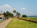 Galle, Sri Lanka - March 12, 2022: View of the white stone lighthouse in Galle Fort. Tourists walk around the old city Royalty Free Stock Photo
