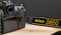 Galle, Sri Lanka - 02 17 2021: Nikon d850 neck strap and camera body on top of a table. yellow letters branding in nylon strap