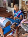 GALLE, SRI LANKA - 03/18/2019: Old Indian woman making bobbin l