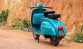 Galle, Sri Lanka - 06 21 2020: Old vintage scooter motorbike in display against clay wall. light blue color and two-seaters, Royalty Free Stock Photo