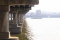 Gallery of the columns of the bridge. Under the bridge over the river.