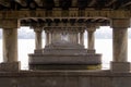 Gallery of the columns of the bridge. Under the bridge over the river.