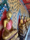 Gallery with old vessels of the seated Buddha in the Buddhist temple Wat Arun. Bangkok, Thailand Royalty Free Stock Photo