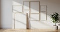 Gallery wall arrangement of multiple blank frames on a white wall with a potted plant Keywords: gallery wall, frames Royalty Free Stock Photo