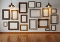 Gallery wall of empty picture frames on white brick wall Royalty Free Stock Photo