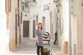 Gallipoli, Apulia - A woman with a stroller in a middle aged all