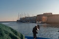 Gallipoli, Italy 20 August 2019: Empty fishermen boat is docked nearby Gallipoli castle at the sunset