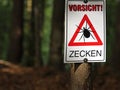 Gallner, Bavaria, Germany, August 15, 2022, Warning sign on tree in a forest with german inscription of Attention, Ticks Royalty Free Stock Photo