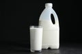 Gallon bottle and glass of milk on black table Royalty Free Stock Photo