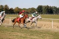 Galloping race horses and jockeys